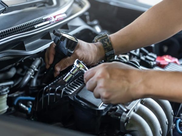 Mans-Hands-Using-a-Wrench-to-Install-a-Spark-Plug